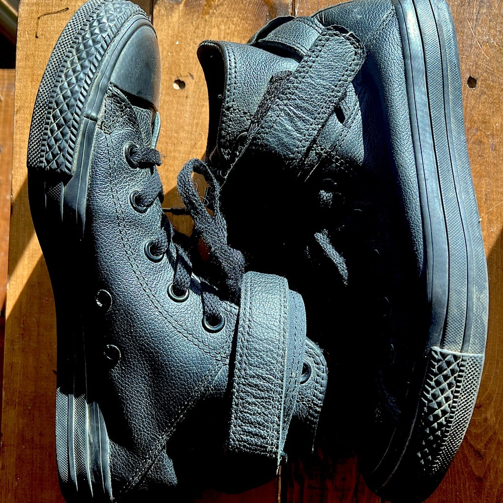 Black leather converse high top sneakers.